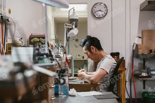 Preview: Male jeweller working at workbench