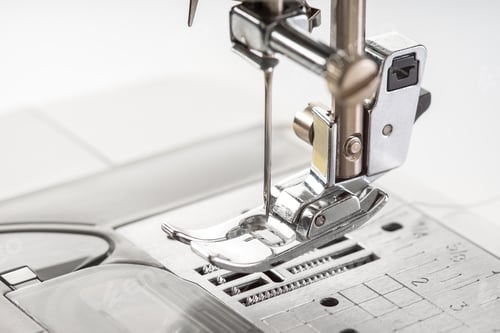Preview: Modern white sewing machine presser foot closeup, macro