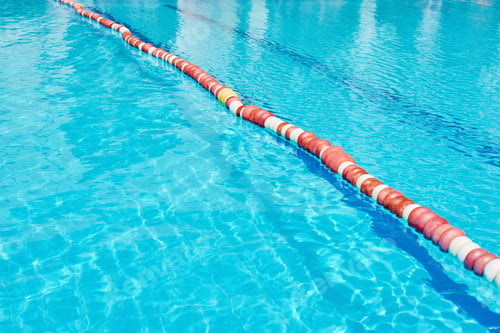 Preview: Background of water in blue swimming pool, water surface with a sun reflection