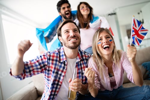 Preview: Group of friends having fun at home, watching game and enjoying together