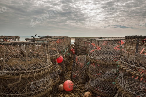 Preview: Weathered fishing traps under a moody sky at the seaside