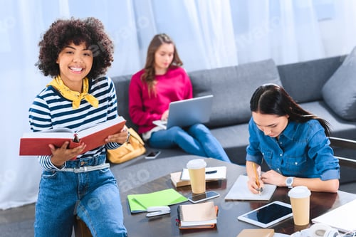 Preview: multicultural group of young students studying together