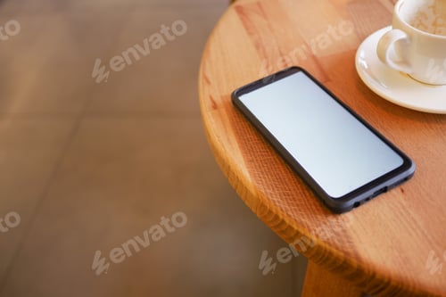 Preview: Relaxing coffee break with a smartphone on the table