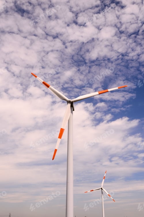 Preview: Vertical shot of a renewable wind turbine against the cloudy sky, alternative energy source concept