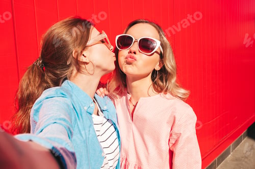 Preview: Two young beautiful women posing outdoors