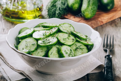Preview: Fresh green cucumbers and dill salad bowl with olive oil