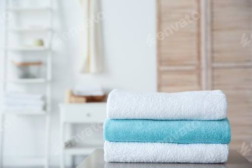 Preview: Stack of towels on table against blurred background