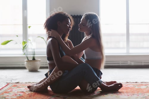 Preview: Young pretty woman with blond hair and nice african american wom