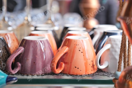 Preview: colorful coffee cup lined up on a coffee machine at cafe .