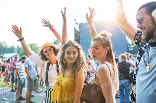 Preview: Front view portrait of group of young friends dancing at summer festival.
