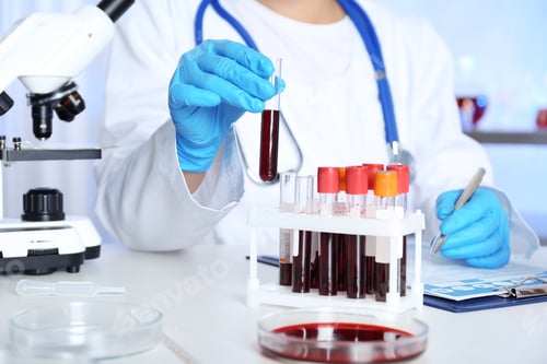 Preview: Female scientist working at table in laboratory. Research and analysis