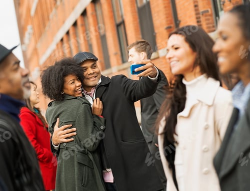 Preview: A group of people on the go on their phones,in the city,taking pictures