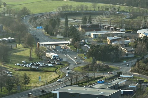 Preview: Aerial view of road roundabout intersection with moving heavy traffic.