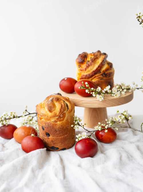 Preview: Festive table setting, Easter pastries on a wooden stand and cherry blossoms. Easter holiday concept