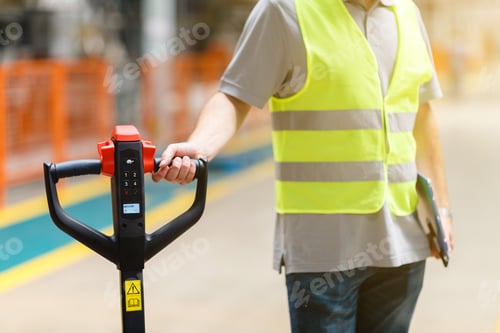 Preview: Employee holding hand pallet truck jack on warehouse