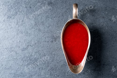 Preview: Cranberry sauce in a gravy boat on gray slate free space