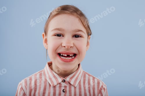 Preview: little girl without teeth, isolated on blue background,