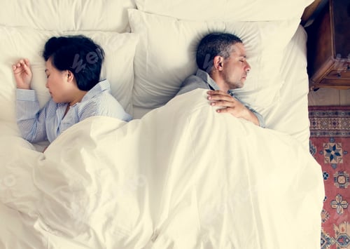 Preview: Interracial couple sleeping back to back on the bed