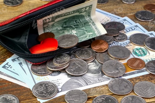 Preview: Open wallet with us coins, american dollars banknotes and red heart.