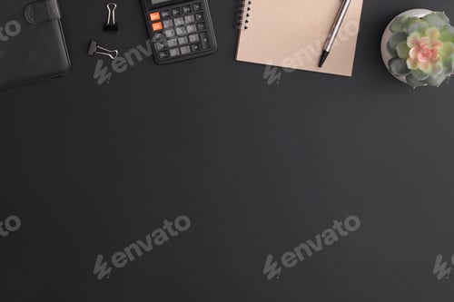 Preview: Black leather office table with calculator, notebook and green plant. Top view with copy space