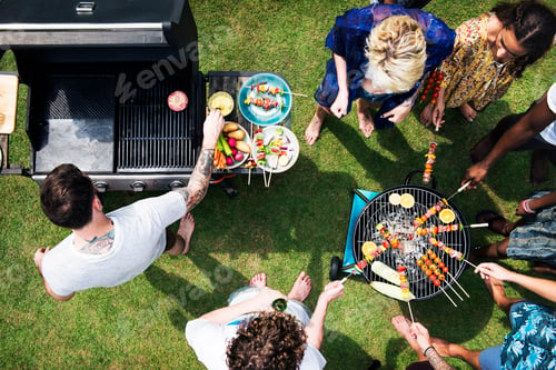 Preview: Aerial view of diverse friends grilling barbecue outdoors