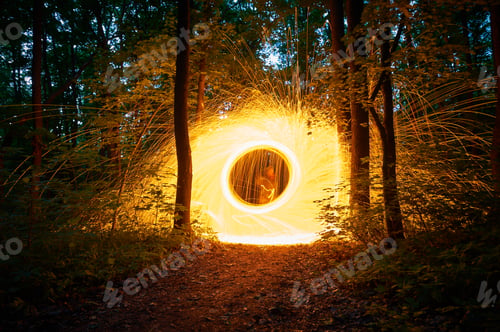 Preview: Burning steel wool spinned in the forest. Showers of glowing sparks from spinning steel wool