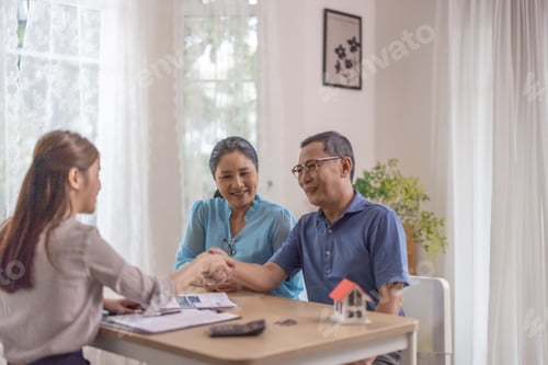 Preview: Elderly couples satisfying retirement home purchase with contract and key handover from a saleswoman