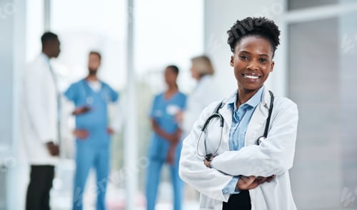 Preview: Portrait of a young doctor standing in a hospital