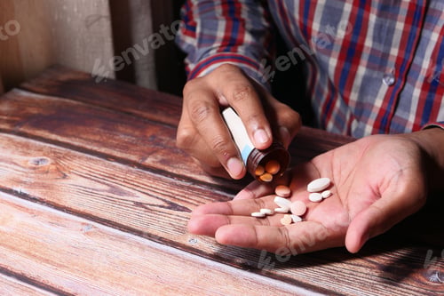 Preview: young man taking medicine, Close up