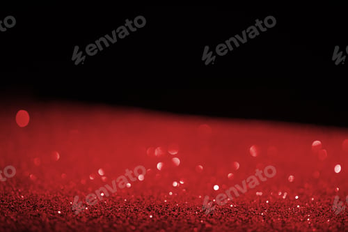 Preview: blurred red glowing glitter on black background