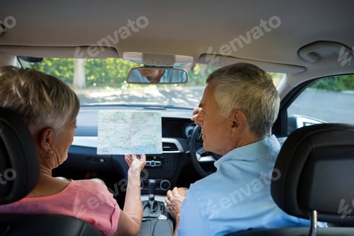 Preview: Senior couple discussing over map in car