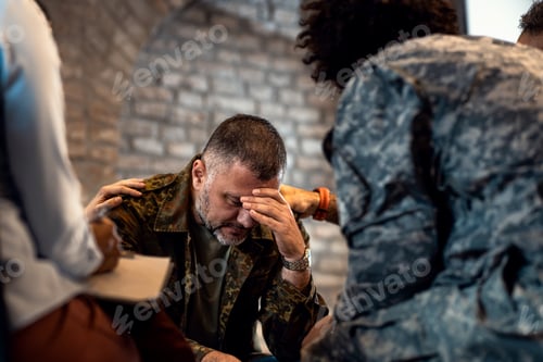 Preview: Group of diverse veterans talking during PTSD support group.