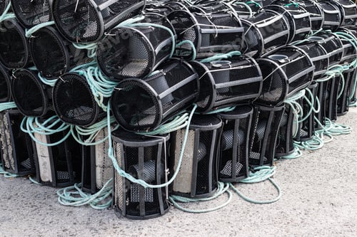 Preview: Group of stacked Crab and lobster pots or traps on a Harbor