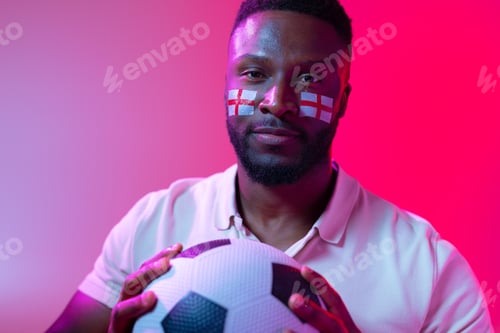 Preview: Image of african american male soccer fan with flag of england in neon pink lighting