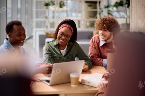 Preview: Happy students cooperating while studying for upcoming exams at the university.