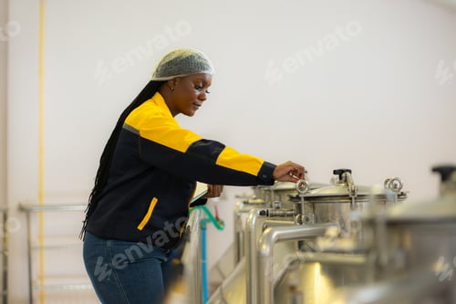 Preview: Young woman working in wine cellar at winery