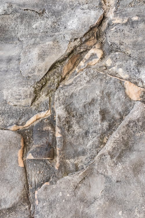 Preview: Chic vertical background of grey stone of natural origin. rough cracks in the rock