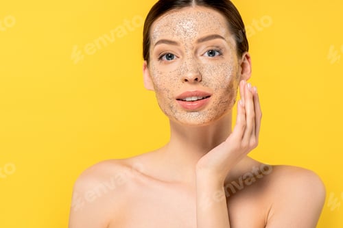 Preview: portrait of naked young woman applying mask, isolated on yellow