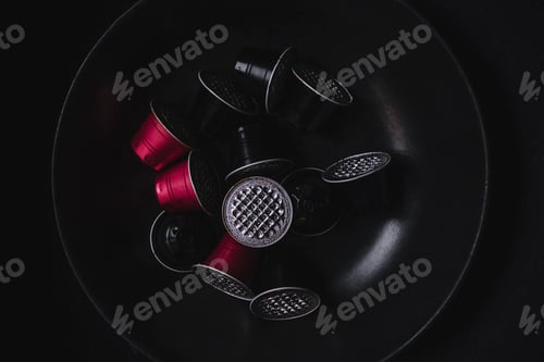 Preview: Set of used red and black coffee capsules.