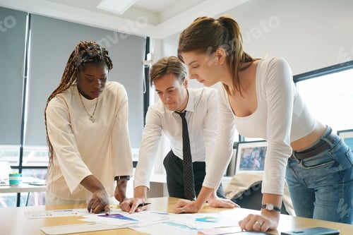 Preview: Coworkers working together in boardroom, brainstorming, discussing and analyzing business strategy.