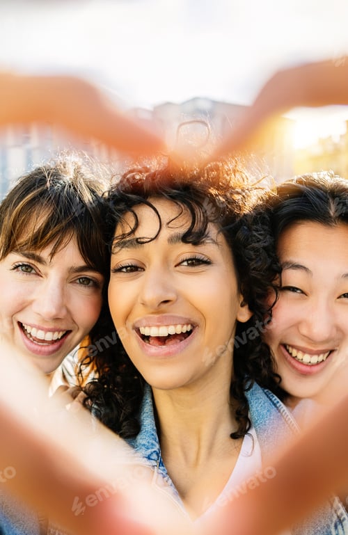 Preview: Smiling Women Friends Making Heart Shape with Hands