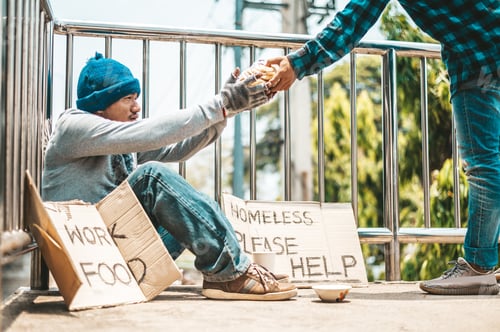 Preview: The man sitting begging on an overpass.