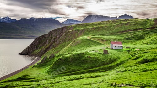 Preview: Cottage and green mountains above the fjord, Iceland