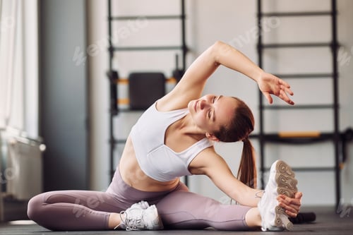 Preview: Yoga exercises and streching. Young beautiful woman in sportive clothes have fitness day in the gym