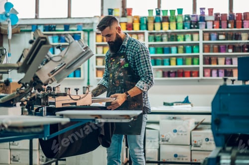 Preview: Male worker using printing machine in a workshop