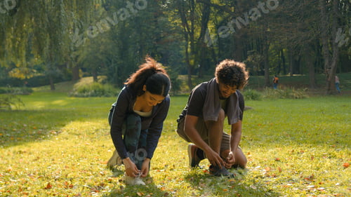 Preview: Two people woman man runners sportive girl guy Indian Arabian couple standing in park outdoors