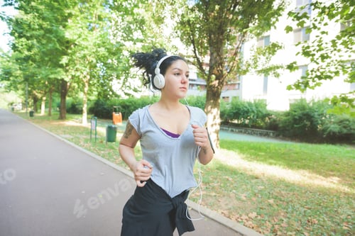 Preview: sportive young mixed race curly black hair woman running