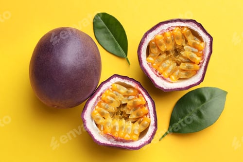 Preview: Fresh passion fruits with green leaves on yellow background, above view