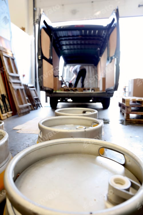 Preview: Worker in brewery, preparing to distribute barrels of beer