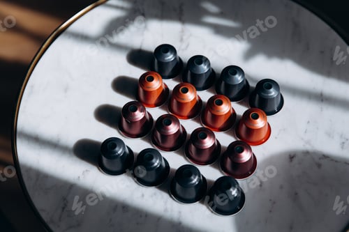 Preview: Four rows of coffee capsules with shadow on table